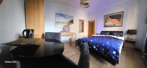 a bedroom with a bed and a table and a desk at Serenity Big Room in Brussels