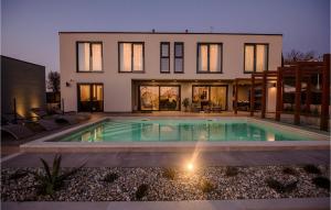 a house with a swimming pool in front of it at Villa Carlotta in Vižinada
