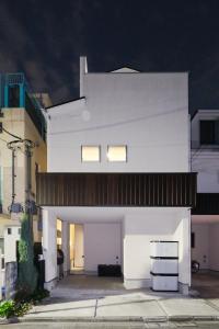 a white house with two windows on top of it at UN-Villa in Tokyo +62 photos