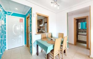 a dining room with a blue table and chairs at Beautiful Apartment In Oropesa Del Mar in Oropesa del Mar