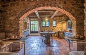 a large kitchen with a stone wall and a table at Casa Politi in San Giustino Valdarno