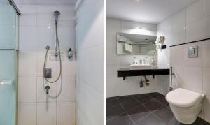 a bathroom with a shower and a toilet and a sink at HOTEL BLACK & WHITE in Visakhapatnam