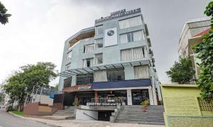 a building with a store in front of it at HOTEL BLACK & WHITE in Visakhapatnam