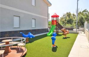 a backyard with a playground with artificial grass at Nice Home In Nocera Terinese With Wifi in Nocera Terinese