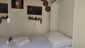 a bedroom with a bed with towels on it at Studio LuxOrange in Massy