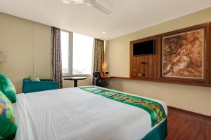 a hotel room with a bed and a painting on the wall at HOTEL BLACK & WHITE in Visakhapatnam