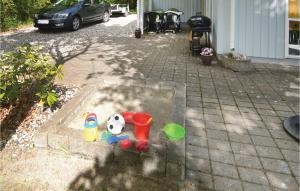 a childs toys are sitting on a patio at Holiday Home Kalvehavestien Glesborg Vi in Fjellerup Strand