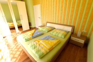 a room with a bed with three pillows on it at Ferienhaus Sonnenschein in Neu Gaarz