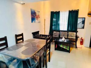 a living room with a dining room table and chairs at Antonios Loft Laiya Batangas in Laiya