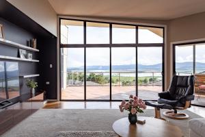 a living room with a large glass door at River Haven serene spacious with river views in Launceston