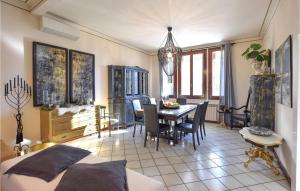a bedroom with a table and a dining room at 3 Bedroom Nice Home In Rosolina in Rosolina