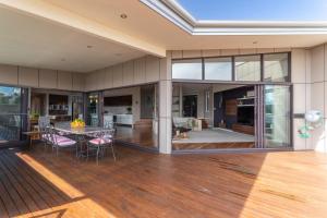 an open living room and dining room with a table and chairs at River Haven serene spacious with river views in Launceston