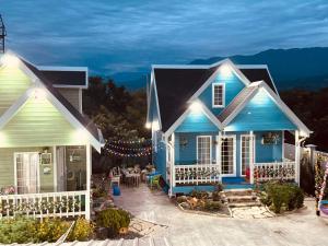 a blue house with a patio in front of it at Luxurious Cottages in Batumi with a Pool in Batumi