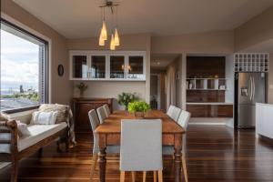 a kitchen and dining room with a table and chairs at River Haven serene spacious with river views in Launceston