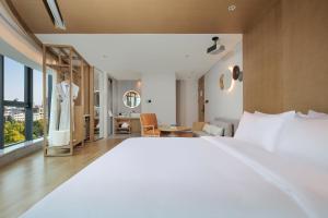 Ένα ή περισσότερα κρεβάτια σε δωμάτιο στο Eeril Hotel Futian Port Exhibition Center +30 φωτογραφίες