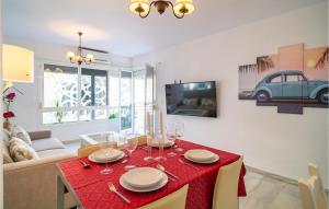 a living room with a table with a red table cloth at Cozy Apartment In Fuengirola With Wifi in Fuengirola