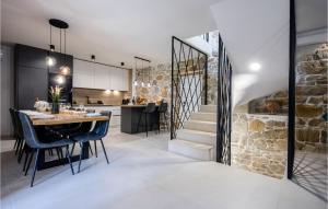 a kitchen and dining room with a stone wall at 4 Bedroom Beautiful Home In Mundanije in Mundanije