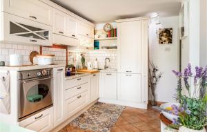 a kitchen with white cabinets and a dishwasher at Lovely Apartment In Rijeka With Wifi in Rijeka