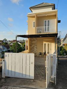 a house with a white fence in front of it at Kanaka 2 storey House Nusadua in Badung