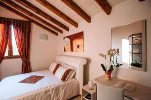 a bedroom with a bed and a desk and a mirror at Brick House Silea in Silea