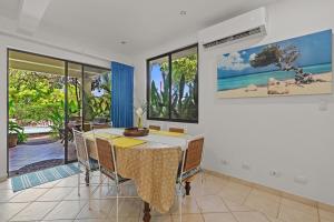 a dining room with a table and views of the ocean at Sunshine Escape with a Rooftop Patio in Coco
