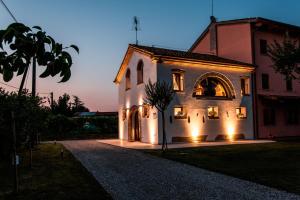 a house with lights on the side of it at Brick House Silea in Silea