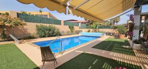 a swimming pool in the backyard of a house at Chalet Molly in Costa de Antigua