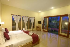 Postel nebo postele na pokoji v ubytování Asri Sari Villa Ubud