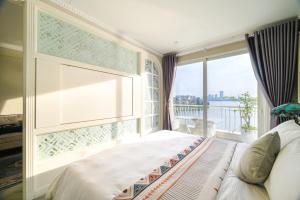 Postel nebo postele na pokoji v ubytování Luxe Paradise Suites Xuan Dieu + 37 fotografií