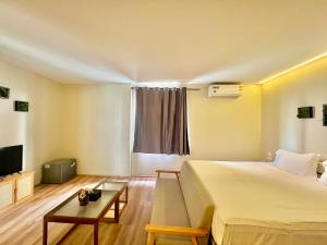 a hotel room with a bed and a tv at patong sunset villa Phuket in Patong Beach +59 photos