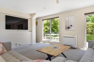 a living room with a couch and a table at Tokenburg Townhouse in Launceston