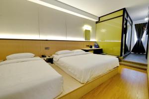 Ένα ή περισσότερα κρεβάτια σε δωμάτιο στο Ming Paragon Hotel