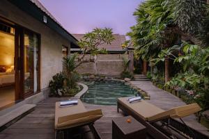 a swimming pool in the middle of a yard at Monique Ubud Villa in Ubud