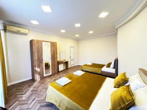 a hotel room with two beds and a mirror at Nizami Luxury Apart in Baku