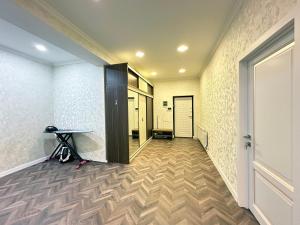 an empty hallway with a table and a door at Nizami Luxury Apart in Baku
