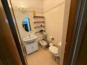 a bathroom with a sink and a toilet and a mirror at Alassio centro e mare in Alassio