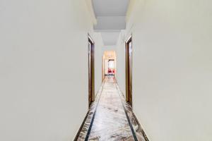 a corridor of a room with white walls and ceilings at Super Hotel O Adarsh Nagar Near Kavya Hospital in Visakhapatnam