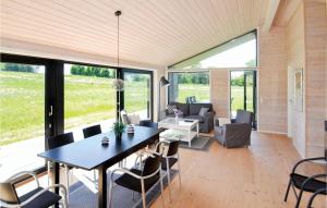a living room with a table and chairs at Three-Bedroom Holiday Home In Grenaa in Grenå