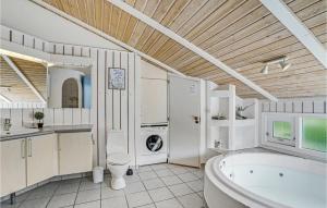 a bathroom with a tub and a sink at Nice Home In Vestervig With Wifi in Hinge