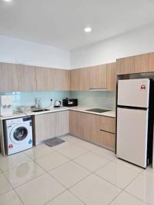 a kitchen with a refrigerator and a washing machine at Green Haven Unique Relaxing Home & Netflix in Masai