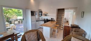 eine Küche mit einer Theke und einer Treppe darin in der Unterkunft Wild Plum Cottage in Kei-mouth Village