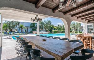 an outdoor dining room with a large wooden table and chairs at La Dolce Vita in San Costanzo