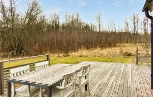 a wooden table and chairs on a wooden deck at Gorgeous Home In Olofström With Wifi in Olofström +11 photos