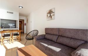 a living room with a couch and a table at Pet Friendly Apartment In Torrevieja in Torrevieja