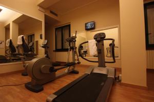 a gym with tread machines and a mirror at Albergo Della Roccia in Varano deʼ Melegari