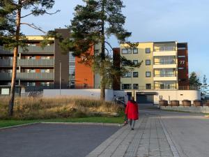 a woman walking down a street in front of a building at Peer Gynts vei 77 in Moss +2 photos