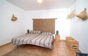 a bedroom with a bed in a white room at Cozy Home In Villanueva De Algaidas in Villanueva de Algaidas