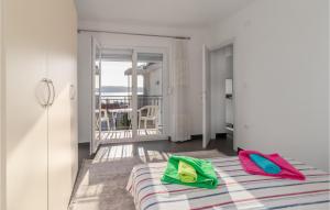 a room with a bed with colorful pillows on it at Awesome Apartment In Crikvenica in Crikvenica