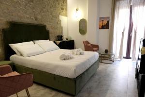 Postel nebo postele na pokoji v ubytování Palazzo Matilde