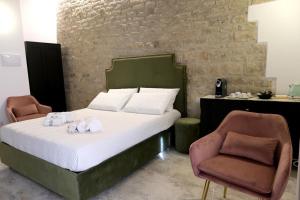 Postel nebo postele na pokoji v ubytování Palazzo Matilde